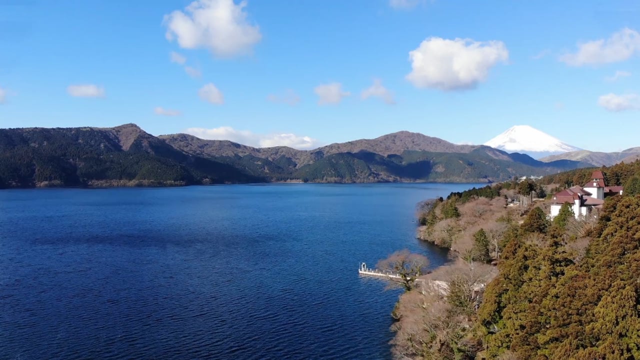 Lake Ashi and forested mountains with Mount Fuji on the horizon, filmed by AHARE